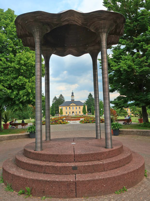 Rundtempel und historisches Haus im Hintergrund im Salinenpark von Bad Rappenau